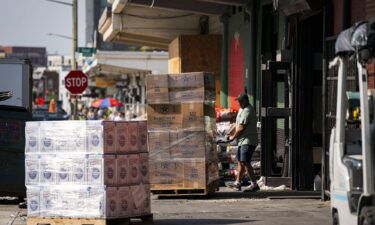 A worker wheels a pallet at a wholesale produce market in the Union Market district in Washington
