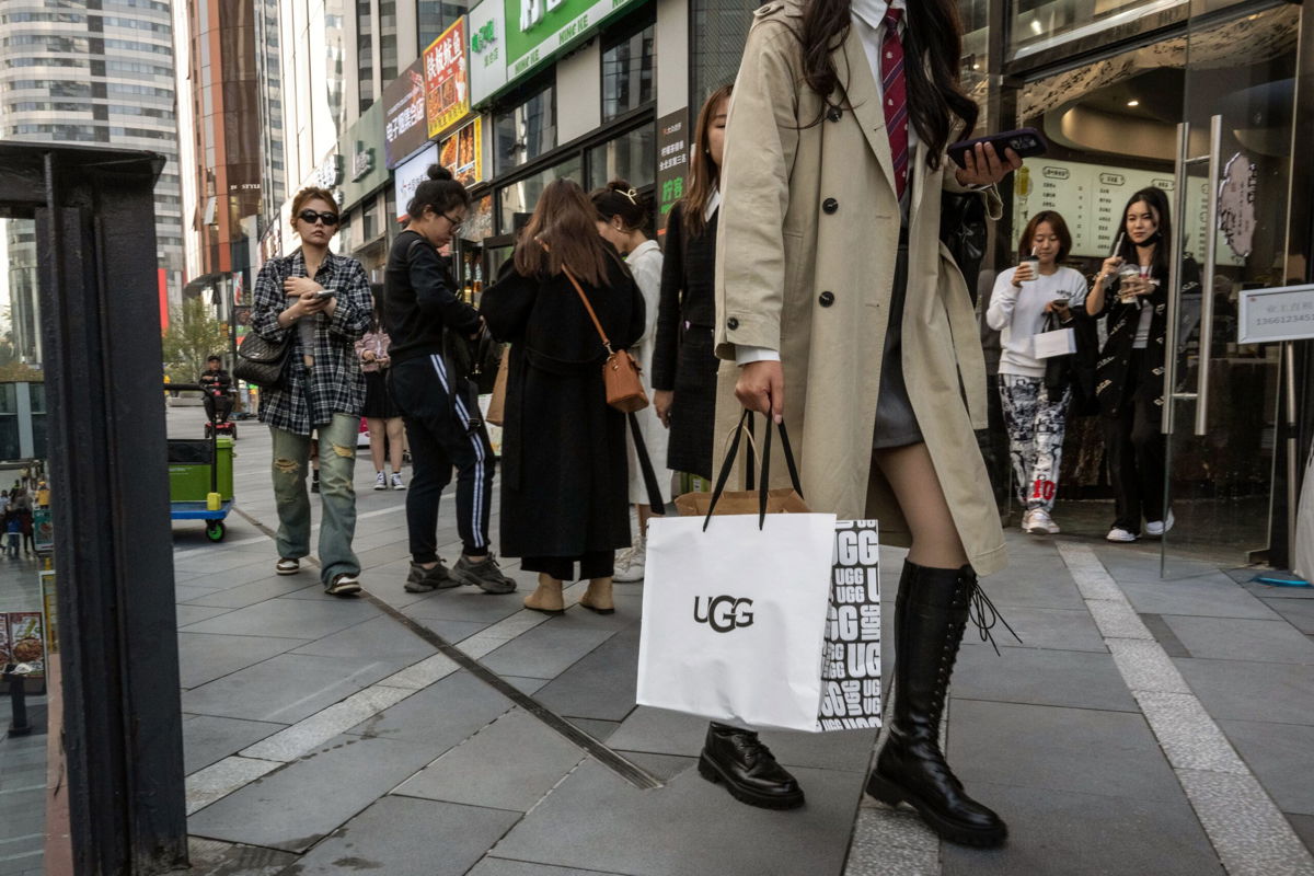 <i>Bloomberg/Getty Images</i><br/>A shopper carries an Ugg Holdings Inc. bag in the Sanlituan area of Beijing