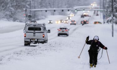 Jodie Gallamore cross-country skis along Tudor Road after a heavy snowfall in Anchorage on Thursday