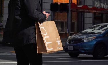 A pedestrian carries a shopping bag while walking through the Union Square shopping district on October 2