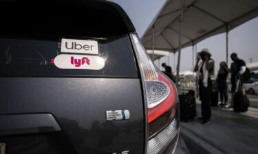 The Uber and Lyft stickers are displayed on a car at LAX Rideshare Lot 1 in Los Angeles