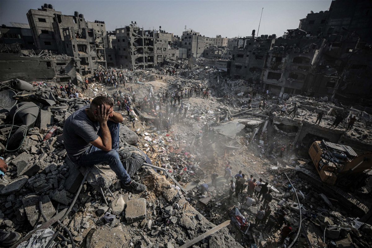 <i>Ali Jadallah/Anadolu/Getty Images</i><br/>A man sits on debris as Palestinians conduct a search and rescue operation after the second bombardment to the Jabalya refugee camp in Gaza City