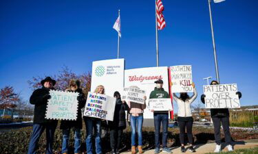 A small number of employees and supporters picket outside the headquarters of drugstore chain Walgreens during a three-day walkout by pharmacists in Deerfield