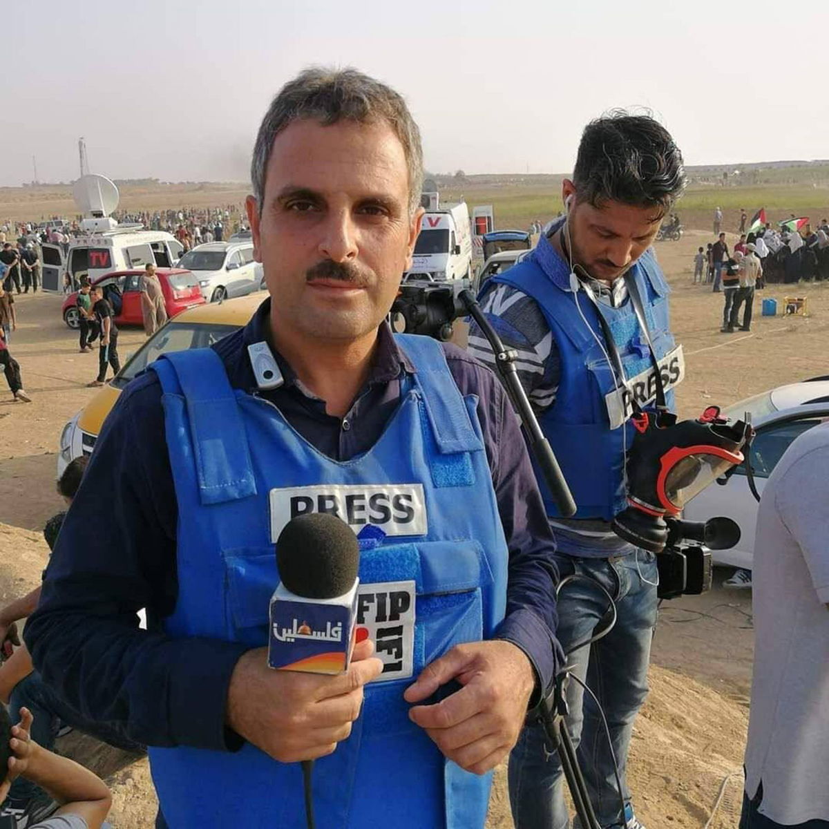 <i>Palestine TV</i><br/>Palestine TV journalist Salman Al Bashir takes off his vest and helmet while giving an emotional on-air report after the death of fellow Palestine TV correspondent