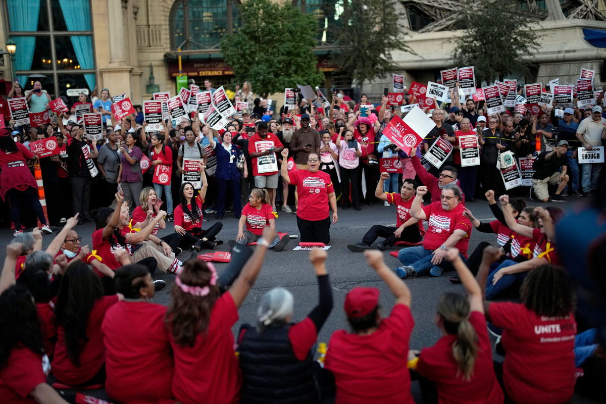 <i>John Locher/AP</i><br/>Members of the Culinary Workers Union block traffic along the Las Vegas Strip on October 25.
