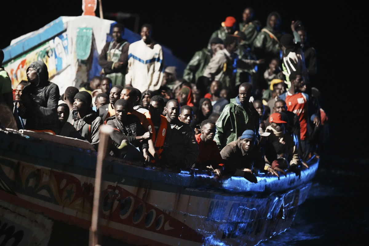 <i>H. Bilbao/Europa Press/Getty Images</i><br/>Dozens of people are seen on their arrival at the dock of La Restinga