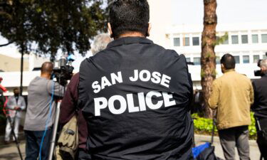 A person wears a San Jose Police jacket during a news conference outside the San Jose Police department in San Jose