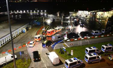 Police vehicles and ambulances arrive at the scene of a security breach at Hamburg Airport