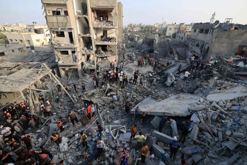 <i>Mahmud Hams/AFP/Getty Images</i><br/>People check the damage at the Al-Maghazi refugee camp on November 5.