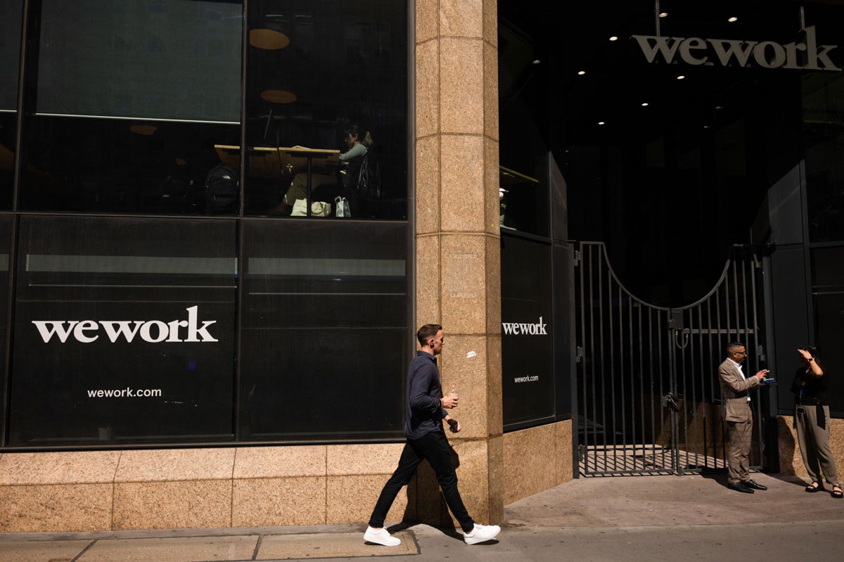 <i>Jose Sarmento Matos/Bloomberg/Getty Images</i><br/>Visitors outside a WeWork Inc. co-working office in London