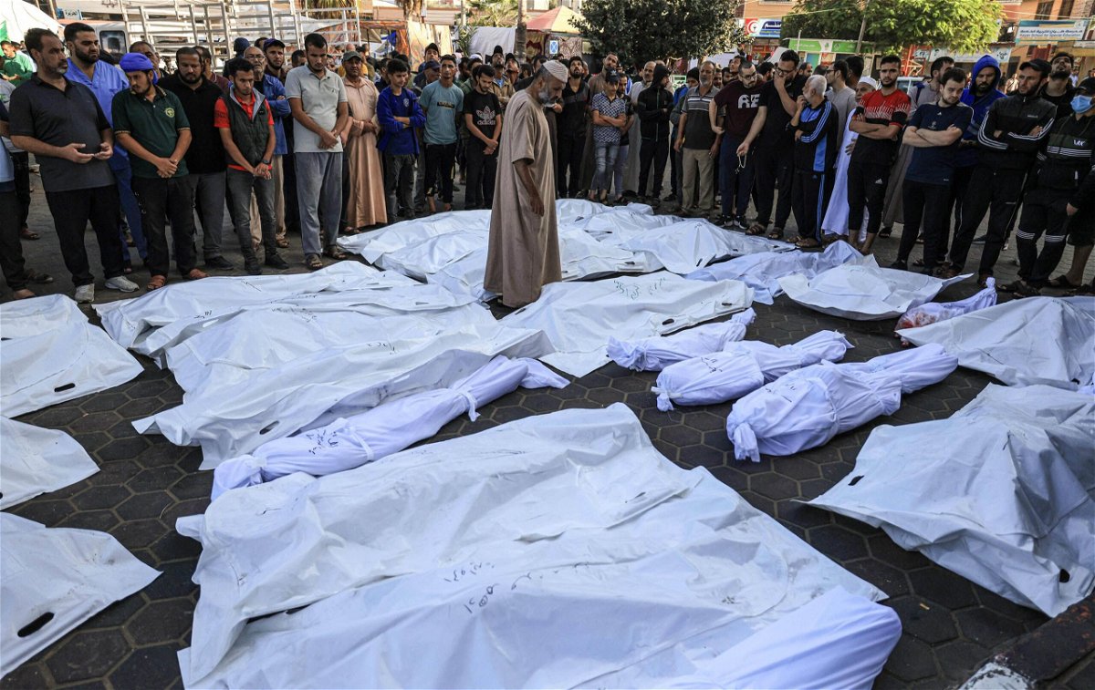 <i>Mahmud Hams/AFP/Getty Images</i><br/>A man walks between the bodies of people killed by Israeli bombardment in Deir Balah