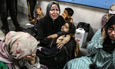 Wounded Palestinians sit in al-Shifa hospital in Gaza City