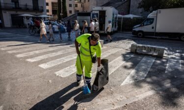 A worker cleans the streets in front of the Cathedral of Santa Maria in Girona