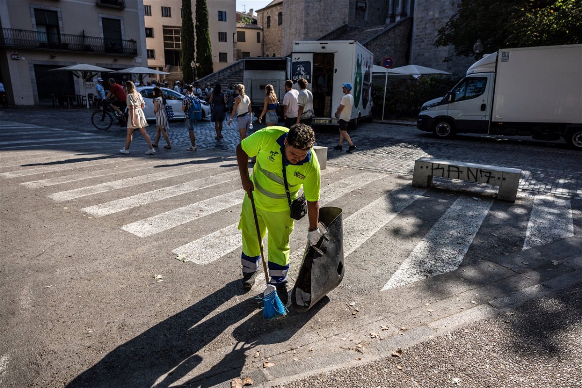 <i>Angel Garcia/Bloomberg/Getty Images</i><br/>A worker cleans the streets in front of the Cathedral of Santa Maria in Girona
