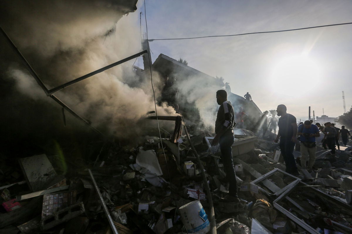<i>Ahmad Hasaballah/Getty Images</i><br/>People search through rubble after Israeli airstrikes in Khan Younis