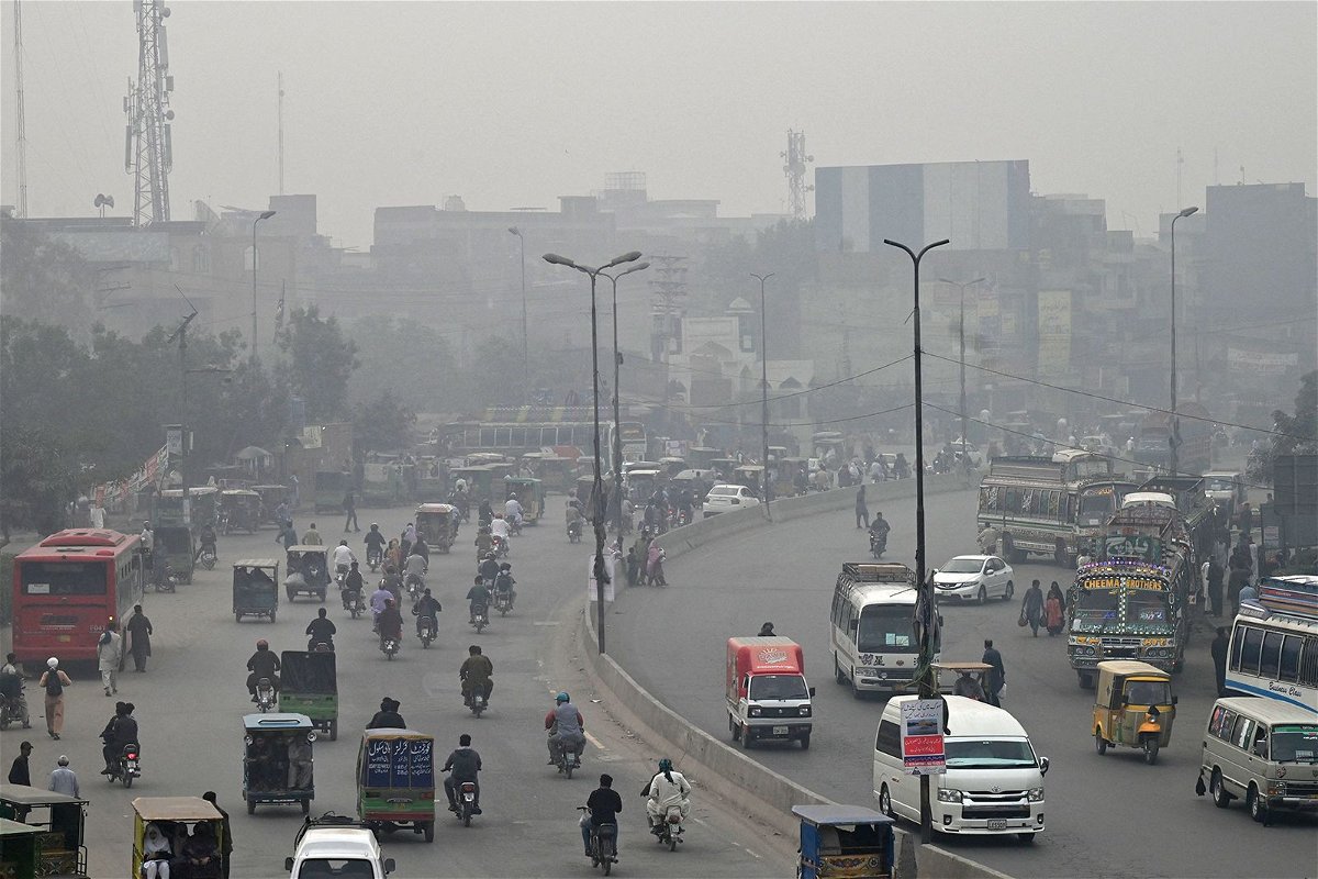 <i>Arif Ali/AFP/Getty Images</i><br/>Commuters make their way through a busy street amid smoggy conditions in Lahore on November 7.