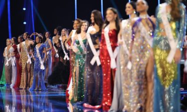 2023 Miss Universe contestants pose on stage during the evening gown presentation during the pageant's preliminary competition.