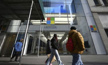 People walk past Microsoft Corp. Fifth Avenue retail store in New York in January 2022. Microsoft stock reached a record high on November 20.