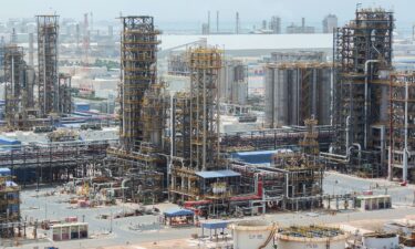 Cracking towers stand at the Ruwais refinery and petrochemical complex