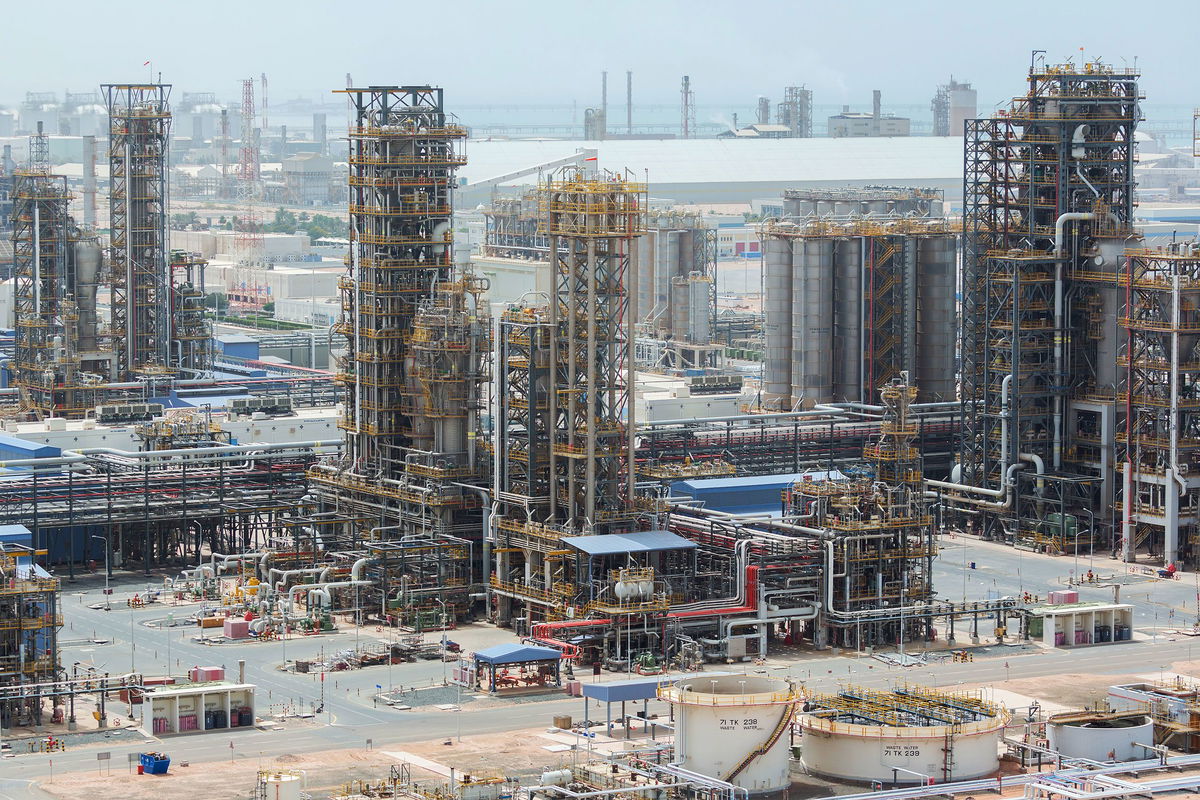 <i>Christophe Viseux/Bloomberg/Getty Images</i><br/>Cracking towers stand at the Ruwais refinery and petrochemical complex