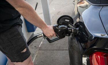 Gas prices could fall further. A customer refuels at a Chevron gas station in San Francisco