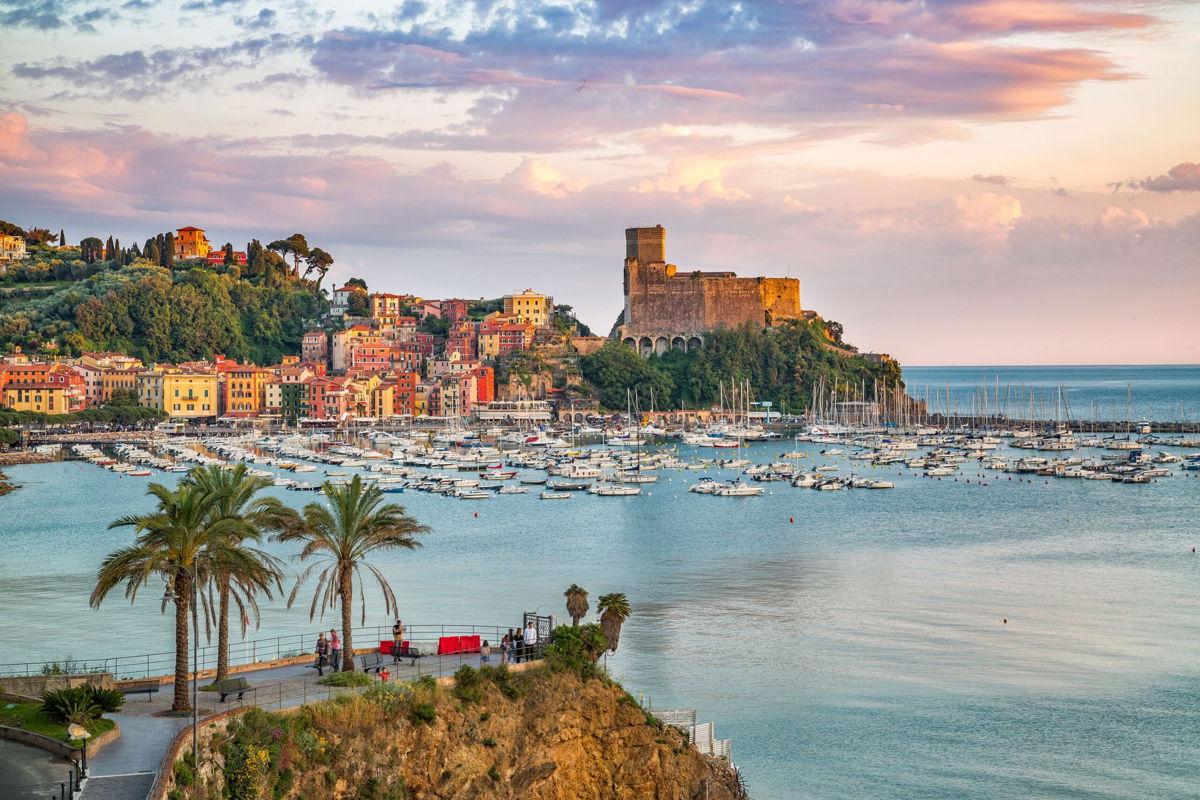 <i>Deb Snelson/Moment RF/Getty Images</i><br/>The village of Lerici on the Ligurian Coast of Italy with a colorful sunset sky.