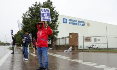 United Auto Workers members strike at a General Motors assembly in October as the rank-and-file membership have ratified the deal