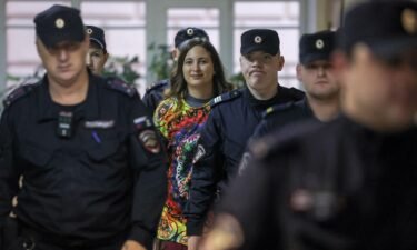 Artist Alexandra Skochilenko is escorted by police officers before a court hearing in Saint Petersburg