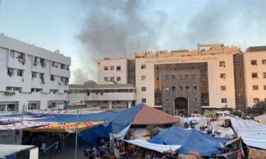 Smoke rises as displaced Palestinians take shelter at Al Shifa hospital