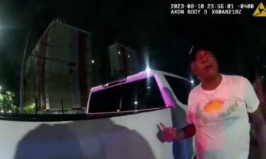 This image from bodycam video provided by the Atlanta Police Department shows Johnny Hollman Sr. speaking with Officer Kiran Kimbrough on August 10.