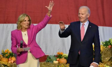 First lady Jill Biden and President Joe Biden wave to service members and their families at Norfolk Naval Station in Norfolk