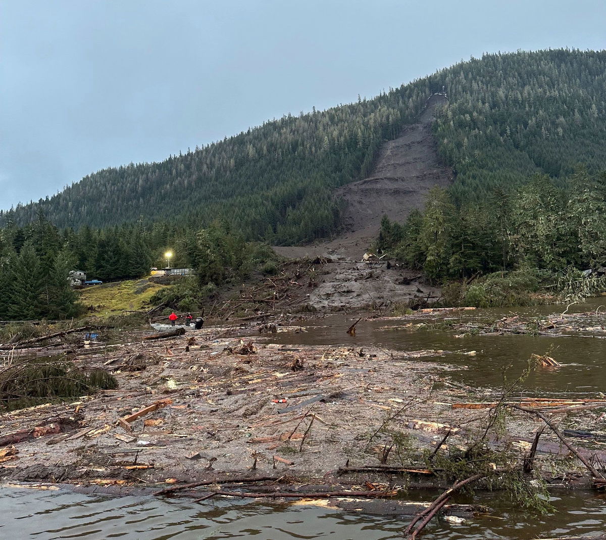 <i>Willis Walunga/Division of Homeland Security and Emergency Management/AP</i><br/>A helicopter arrives as that scene as search and rescue dogs and their handlers stand by on November 22.