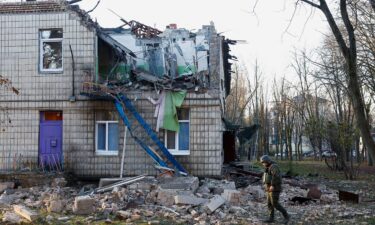 Police officers inspect the compound of a kindergarten damaged during Russian drone strikes in Kyiv