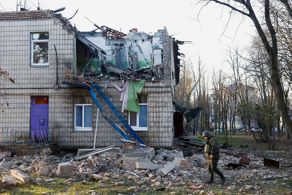 <i>Valentyn Ogirenko/Reuters</i><br/>Police officers inspect the compound of a kindergarten damaged during Russian drone strikes in Kyiv