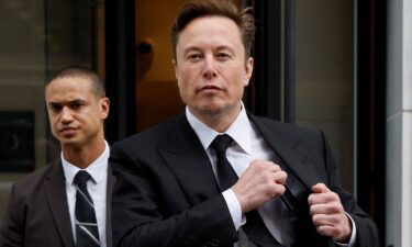 Tesla CEO Elon Musk and his security detail depart the company's local office in Washington
