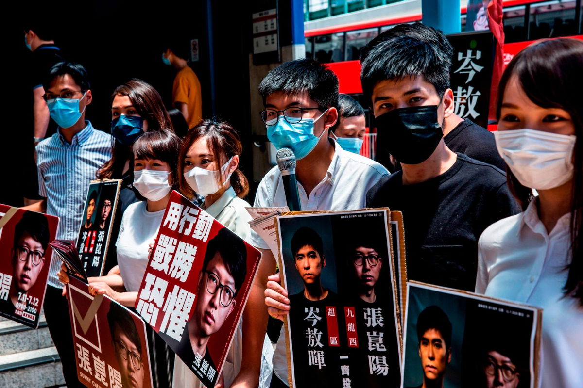 <i>ISAAC LAWRENCE/AFP/AFP via Getty Images</i><br/>Voters waiting to vote during primary elections in Hong Kong on July 12