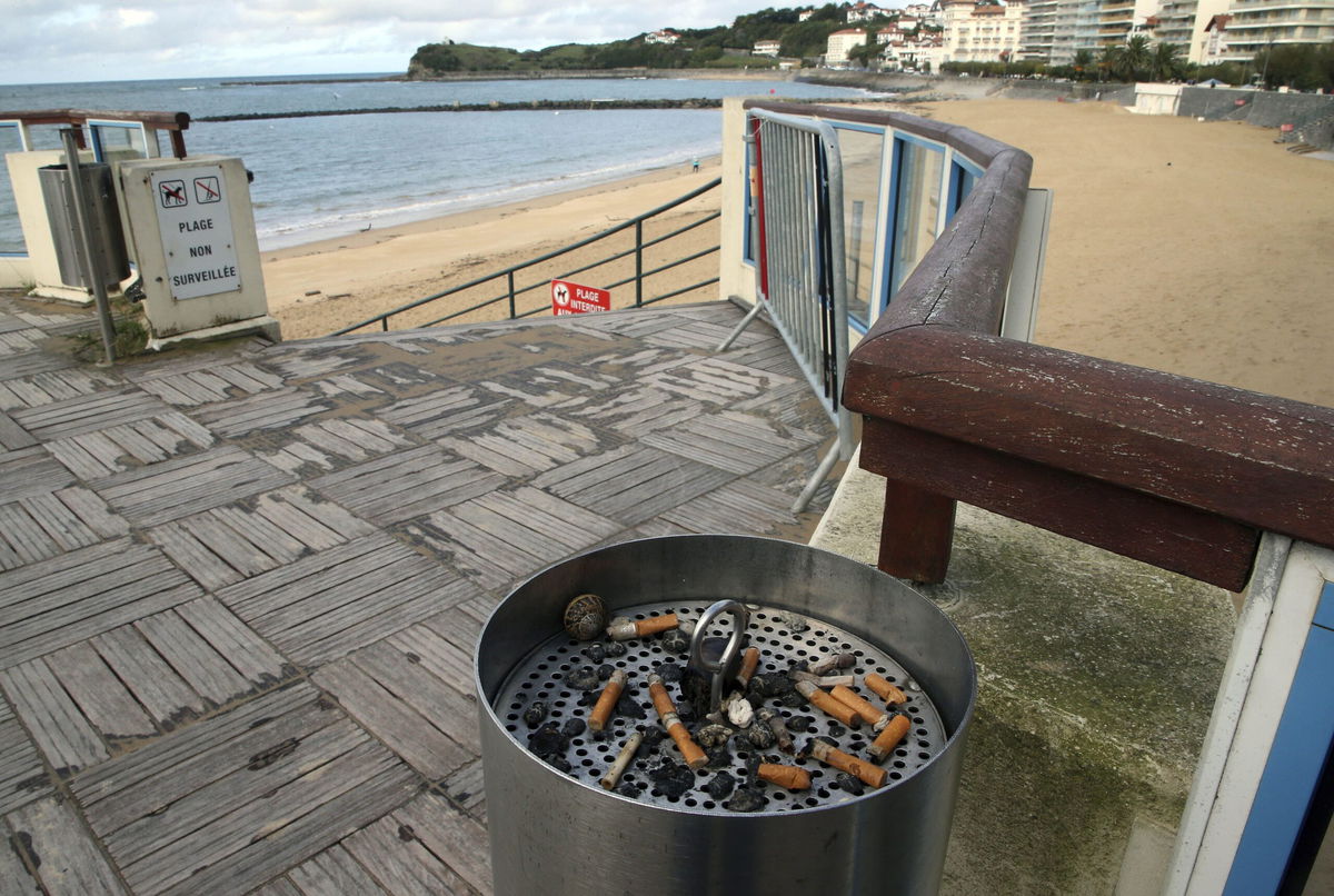 <i>Bob Edme/AP</i><br/>An ashtray with cigarette butts at the edge of the beach