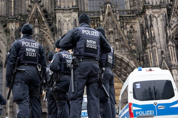 Police are seen at the entrance of Cologne Cathedral, restricting tourists from entering.