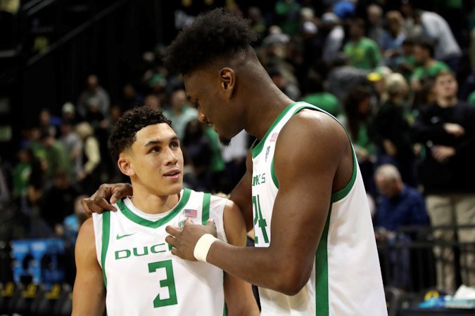 Oregon forward Mahamadou Diawara (24) talks with guard Jackson Shelstad (3) following their team's 64-59 win over UCLA in an NCAA college basketball game in Eugene on Saturday.