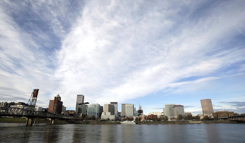 The Portland, Ore., skyline is visible on the bank of the Willamette River, Dec. 3, 2014.