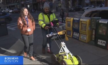 A technician uses an electromagnetic radar to examine sidewalks in Boston's Chinatown neighborhood.