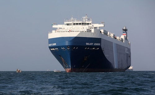 Boats carrying people sail near the Galaxy Leader commercial ship, seized by Yemen's Houthis last month, off the coast of al-Salif, Yemen, December 5.