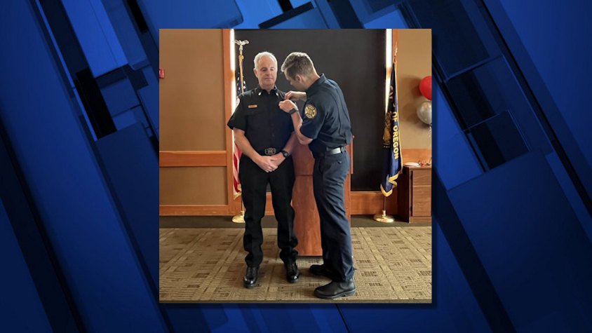 Bend firefighter Brady Boos pins badge on his father, new Sunriver Fire Chief Bill Boos