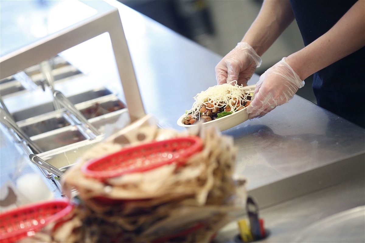 <i>Luke Sharrett/Bloomberg/Getty Images/FILE</i><br/>A customer who threw a burrito bowl in a Chipotle worker's face in September has been sentenced to work in the fast food industry for two months.
