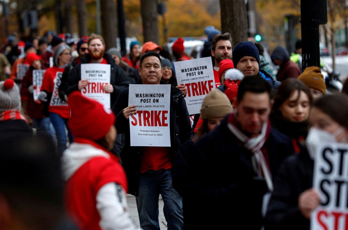 <i>Evelyn Hockstein/Reuters</i><br/>Washington Post staff walk a picket line at the start of a 24-hour strike amid prolonged contract talks outside The Washington Post building in Washington