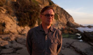 Kevin Cooley looks off into the sunset at Thousand Steps Beach in California