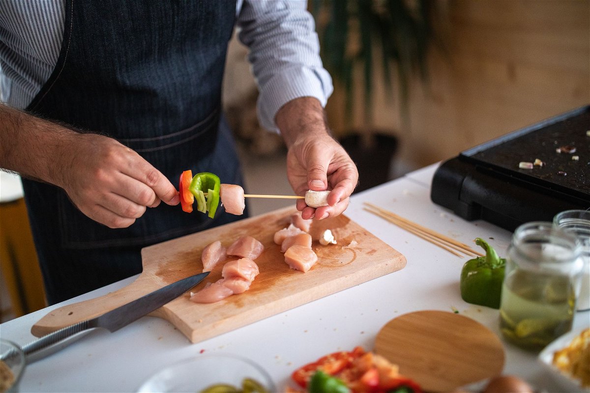 <i>miodrag ignjatovic/E+/Getty Images</i><br/>You should wash your hands before handling food and after every time you touch raw meat. It's wise to avoid using the same utensils on raw and cooked products.
