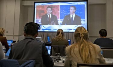 Florida Gov. Ron DeSantis and California Gov. Gavin Newsom appear on screen from the press room during a debate held by Fox News
