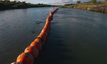 Buoys meant to deter migrant crossings are anchored in the Rio Grande River in Eagle Pass