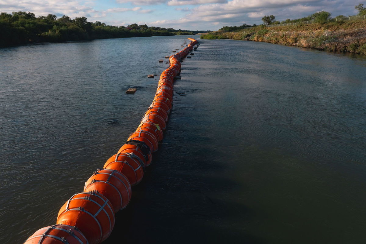 <i>Jordan Vonderhaar/Bloomberg/Getty Images</i><br/>Buoys meant to deter migrant crossings are anchored in the Rio Grande River in Eagle Pass